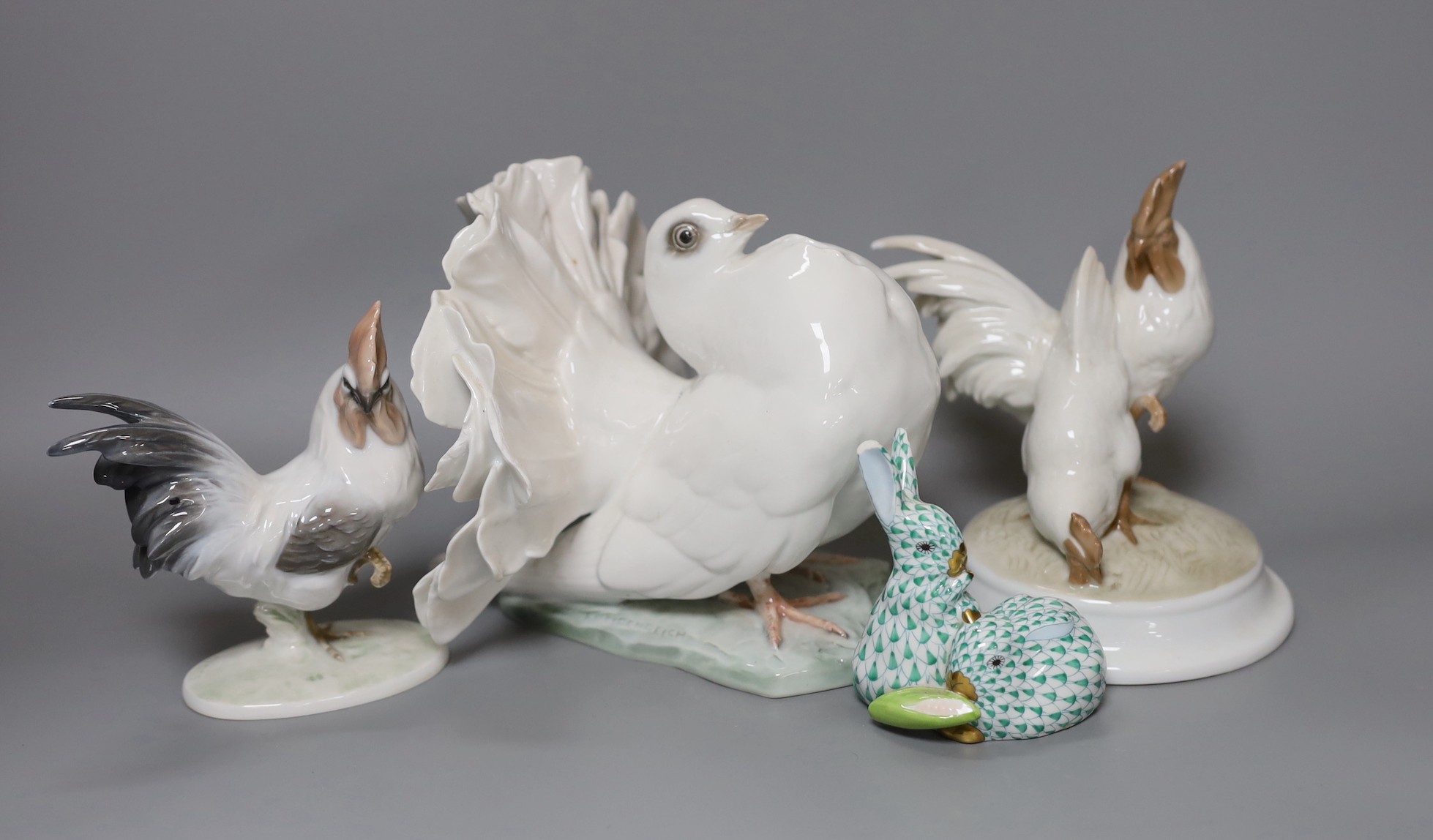 A Herend model of a rabbit, a pair of Rosenthal porcelain models of cockerels and a porcelain pigeon, tallest 15cm, (4)